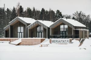 a couple of buildings in the snow at Meriaitat in Kokkola