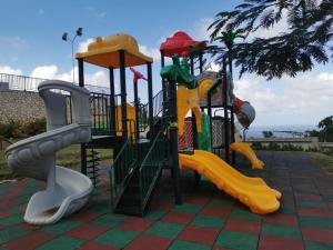 a playground with different types of play equipment at J’s Pyramid Point Vacation Stay in Ocho Rios