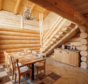 a wooden dining room with a table and chairs at Chalet Rozmarin Predeal in Predeal