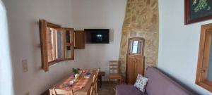 a living room with a table and a couch at ΚΑΦΕΝΕΣ in Kavoúsion