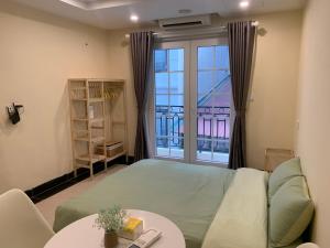a living room with a couch and a window at Mino Homestay in Hanoi