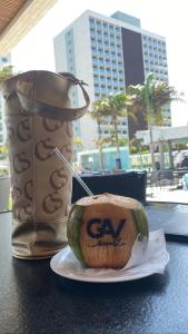 a sandwich on a plate on a table with a drink at Salinas exclusive Ary Costa in Salinópolis
