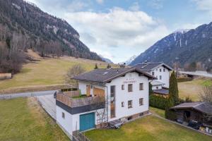 an aerial view of a house with mountains in the background at Sweet Home Apartments in Tösens