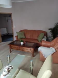 a living room with a couch and a coffee table at Ferienwohnung Henny in Wismar