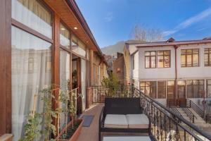 a balcony with a bench on a building at Duplex Opera 3 in Tbilisi City