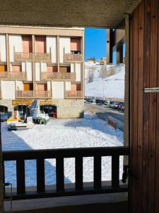 a view from a balcony of a building in the snow at 2 room apartment 200m from the slopes In the heart of the ski resort in Valberg