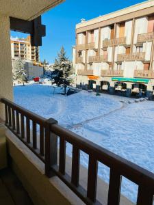 a balcony of a hotel with snow on the ground at 2 room apartment 200m from the slopes In the heart of the ski resort in Valberg