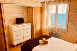 a small bedroom with a bed and a television at 2 room apartment 200m from the slopes In the heart of the ski resort in Valberg