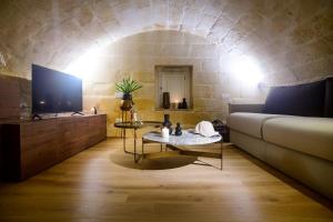 a living room with a couch and a table at Le Malve Cave Retreat in Matera
