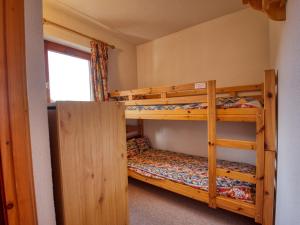 a bedroom with two bunk beds and a window at Appartement Morillon 1100, 3 pièces, 6 personnes - FR-1-642-37 in Morillon