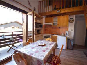 a kitchen and dining room with a table with a table cloth at Appartement Morillon Village, 2 pièces, 4 personnes - FR-1-642-38 in Morillon