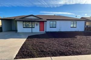 a house with a red door and a driveway at Stylish and Central Mesa Home with Private Pool! in Mesa