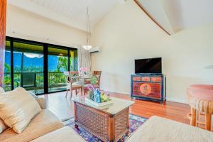 a living room with a couch and a tv at Hanalei Bay Resort 2301 in Princeville