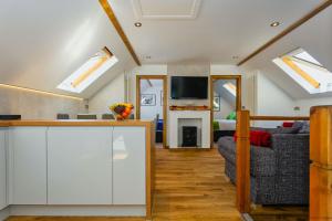 a kitchen and living room with skylights at BISHOPS TAWTON SNOWDROP COTTAGE 3 Bedrooms in Bishops Tawton