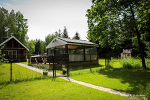 einen Pavillon in einem Park mit einem Zaun im Gras in der Unterkunft Sodybos Narūnas namelis dviems in Jonava