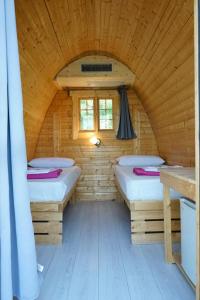 a room with two beds in a wooden cabin at Campeggio Gianna Golfo dei Poeti in Lerici