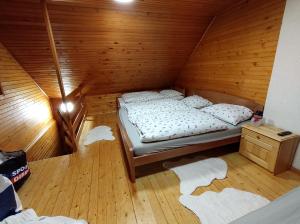 a room with a bed in a wooden cabin at Brunarica 6A - Smučišče Trije Kralji in Oplotnica