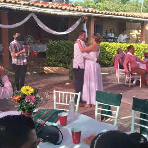 a man and a woman embracing at a wedding at Hotel SPA Campestre Los Adobes in Taxco de Alarcón