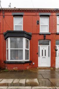 a red brick building with white windows and doors at Air Host and Stay - Talton House, sleeps 5, 7 minutes drive to city centre, free parking in Liverpool