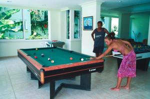 a woman playing a game of pool in a room at Parkmar Apart in Marmaris