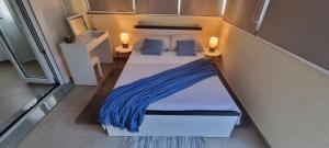 a small bed in a small room with two lamps at Two stars - Villa Sunce in Senj