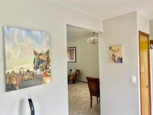 a hallway with a painting of a dog on the wall at Artsy Home close to USAFA with Fireplace and Patio in Colorado Springs