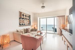 a living room with a couch and a view of the ocean at 2BR Apartment at Aquarella AG02 in Juan Dolio