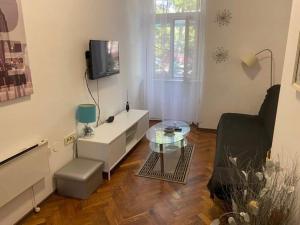 a living room with a glass table and a couch at Alex in Rijeka