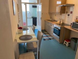 a small kitchen with a table and a counter at Alex in Rijeka