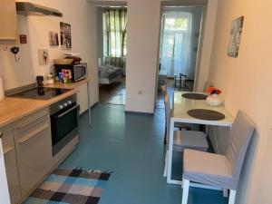 a kitchen with a table and chairs and a table and a kitchen at Alex in Rijeka +22 photos
