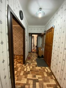 a hallway with a door and a tile floor at Сдам квартиры посуточно in Kokshetau