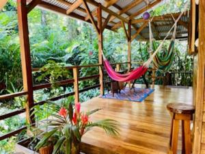 a porch with hammocks on a wooden deck at Casonita in Manzanillo