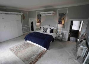 a bedroom with a large bed and a rug at Moulton Grange in Northampton