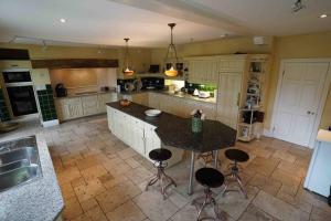 a large kitchen with a island with a counter top at Moulton Grange in Northampton