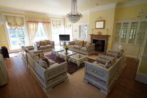 a large living room with couches and a fireplace at Moulton Grange in Northampton