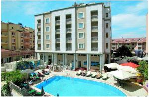 a hotel with a swimming pool in front of a building at Almena Hotel in Marmaris
