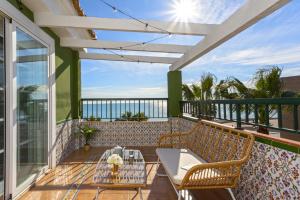a patio with a table and chairs on a balcony at -MalagaSunApts-WEST Malaga Amazing SeaView in Málaga