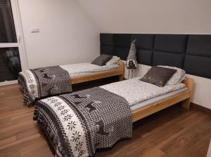 Postel nebo postele na pokoji v ubytování Dom Na Brzoskwiniowej
