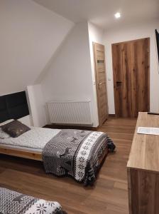 Postel nebo postele na pokoji v ubytování Dom Na Brzoskwiniowej