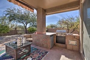 a patio with an outdoor kitchen with a stove at Gold Canyon House with Superstition Mountain Views! in Gold Canyon