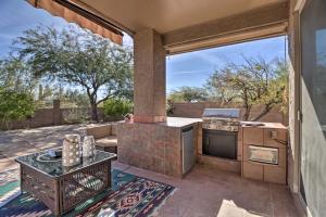 a patio with an outdoor kitchen with a stove at Gold Canyon House with Superstition Mtn Views! in Gold Canyon