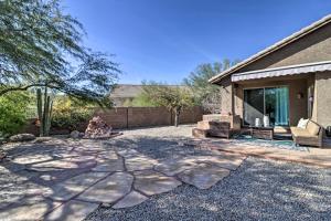 a person sitting in a yard next to a house at Gold Canyon House with Superstition Mountain Views! in Gold Canyon