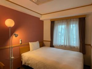 Postel nebo postele na pokoji v ubytování Toyoko Inn Busan Seomyeon
