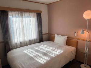 Postel nebo postele na pokoji v ubytování Toyoko Inn Busan Seomyeon