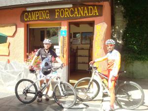 two men standing with their bikes in front of a building at Camping Forcanada in Era Bordeta