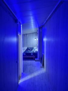 a blue hallway with a bed in a room at In the heart of the city Chisinau in Chişinău