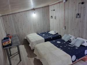 a room with two beds and a table in it at In the heart of the city Chisinau in Chişinău