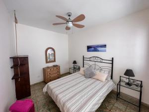 a bedroom with a bed and a ceiling fan at Casa Álamo Agaete in Agaete