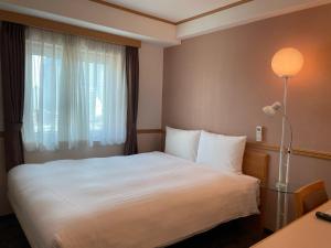 Postel nebo postele na pokoji v ubytování Toyoko Inn Busan Seomyeon