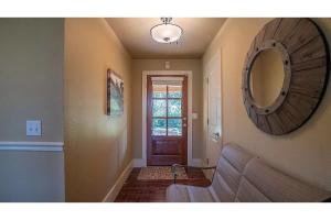 a living room with a couch and a mirror at Grand Lake Reunion House-Community pool, hot tub, lake access in Vinita